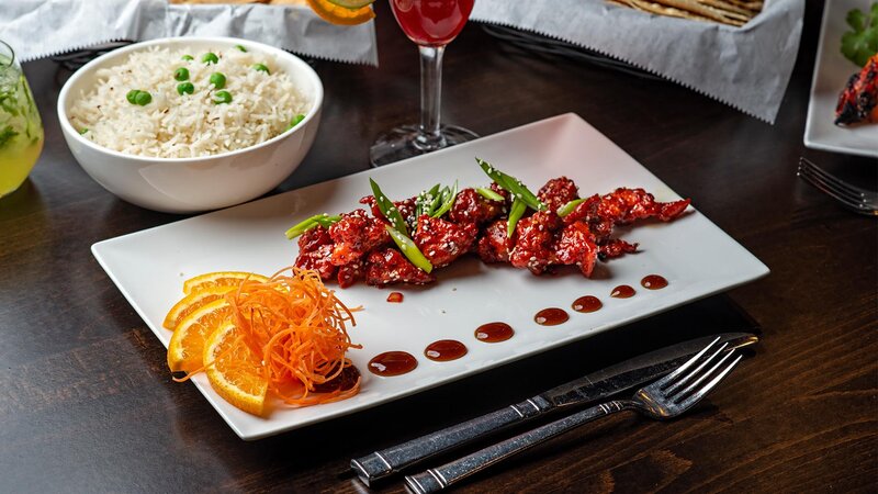 Chicken topped with peppers with a side of rice